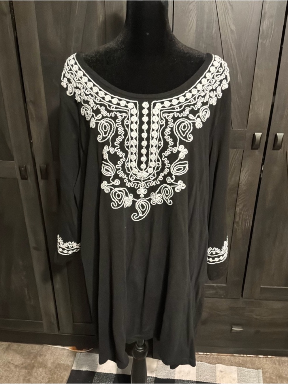 Woman Within Black Tunic with White Embroidered Yoke